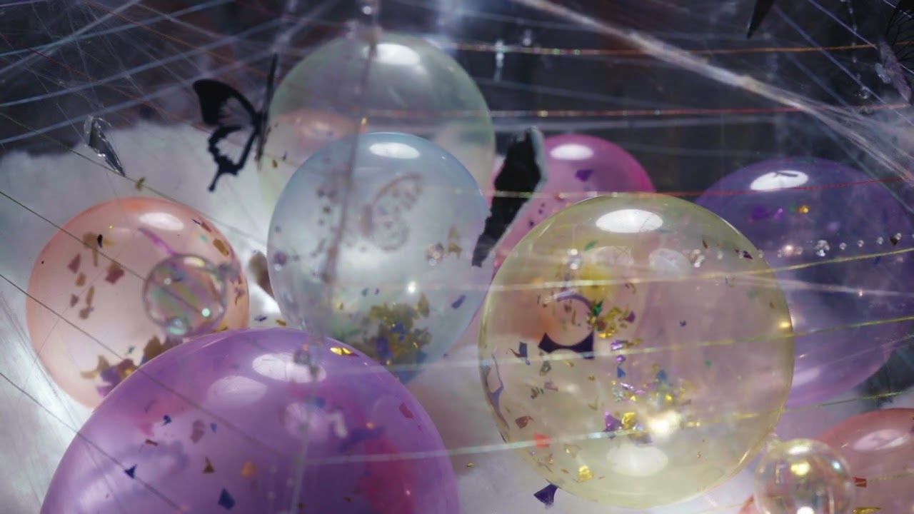 Colorful suspended spheres entangled in threads for Desire Tangles